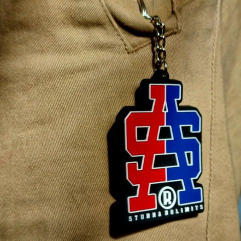 Product  close up image of SA logo keyring inside pockets. Red and blue split coloured