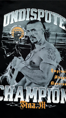 Man with tattoos flexing muscles in front of a 'Undisputed Champion' sign.